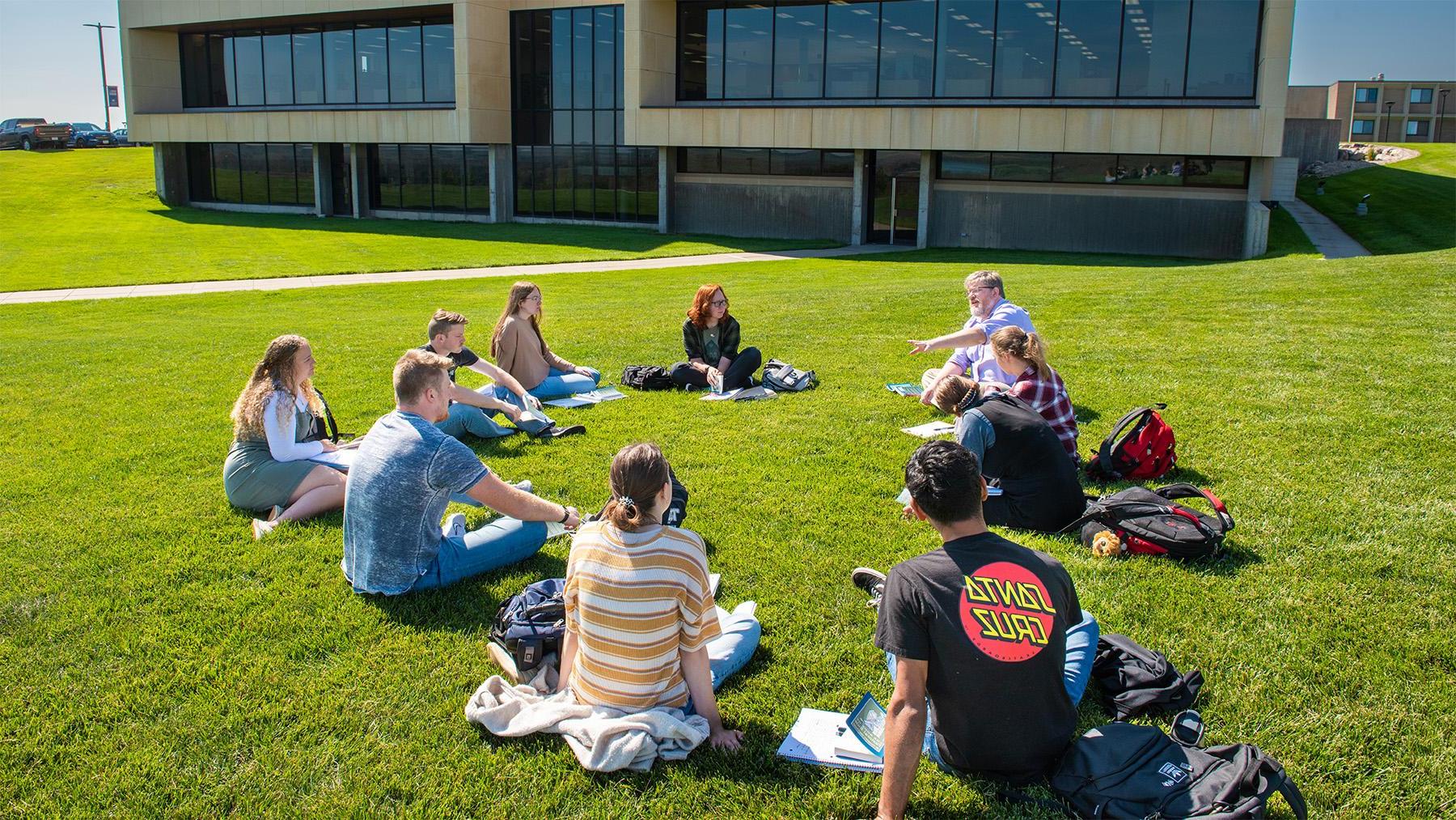 Students with Dr. Collins having class on the shire